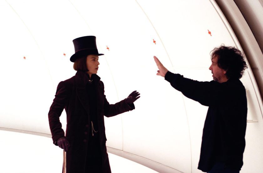 Charlie and the Chocolate Factory Picture 22, Backstage medium prfile BTS shot of Johnny Depp as Willy Wonka facing film director Tim Burton.